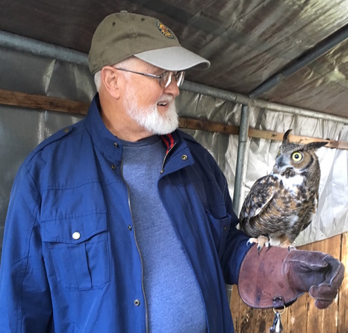 man holding an owl