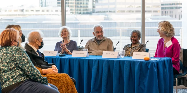 elderly people sitting at a table