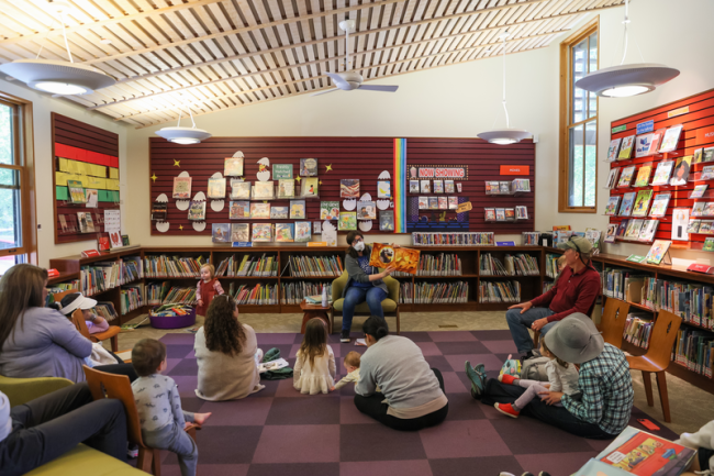 children sitting on the floor in the library